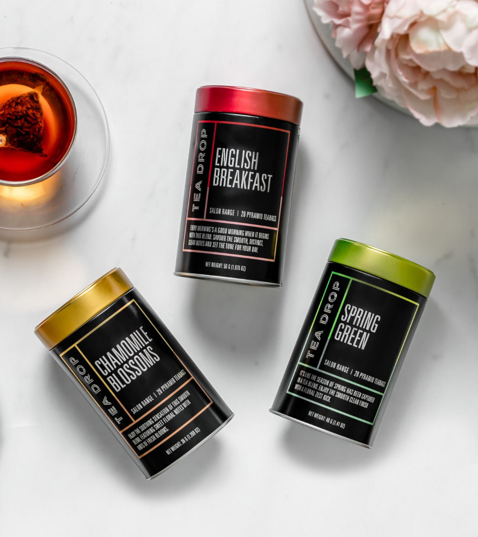 Overhead flat lay of Tea Drop salon-range tins